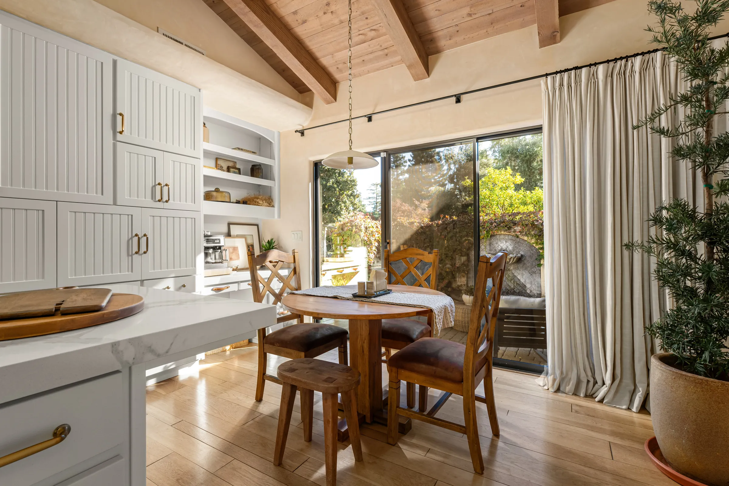 A kitchen opening into a dining nook, the route between the two rooms visible in one frame.